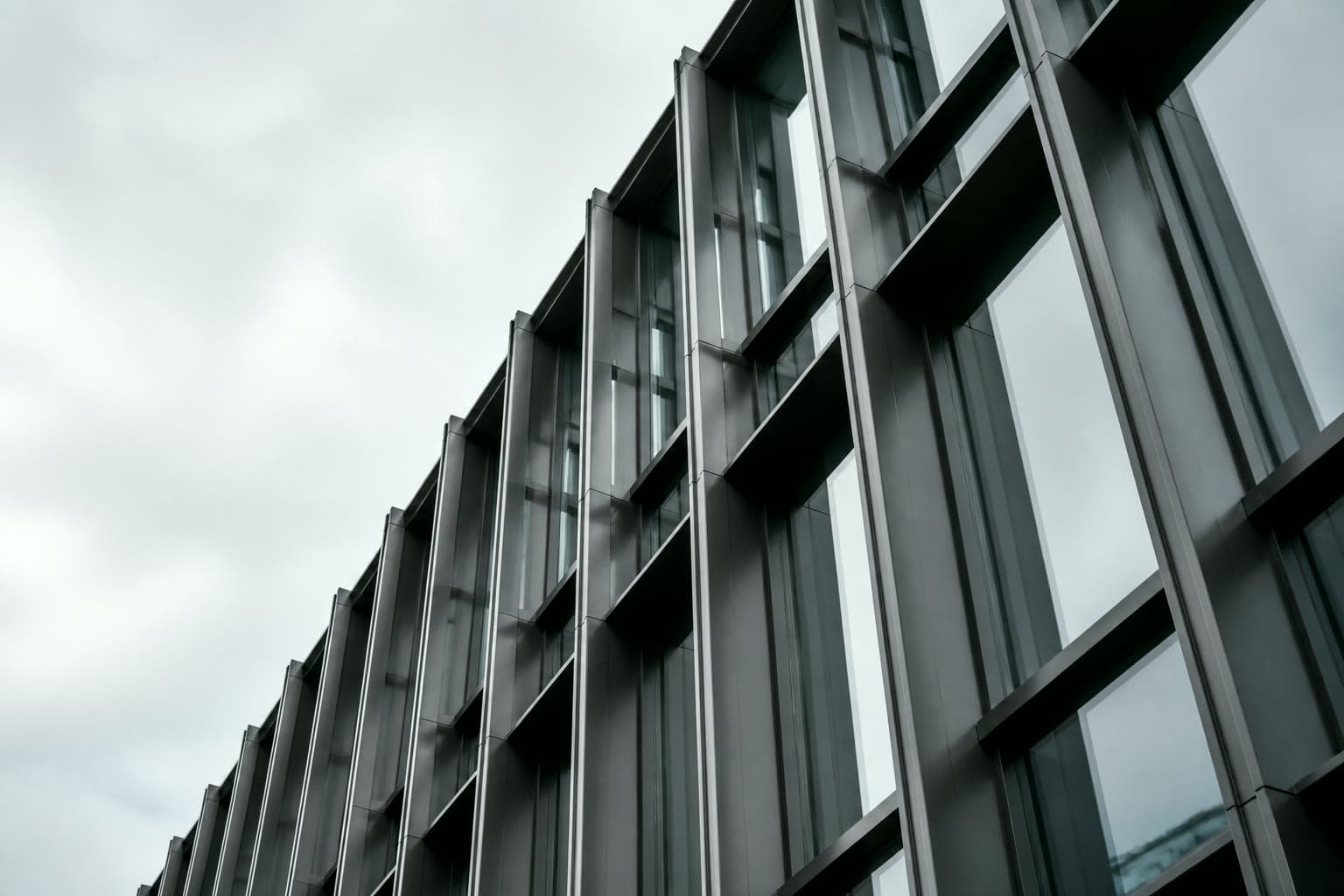 Steel and glass architecture rising into a cool sky